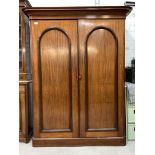 A Victorian mahogany wardrobe, with two panelled doors enclosing interior with slides, drawers an