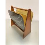 A mid-century walnut and formica two-division magazine rack, raised on triangular shaped end