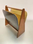 A mid-century walnut and formica two-division magazine rack, raised on triangular shaped end