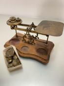 A set of postal style postmaster's letter scales complete with a collection of various weights