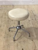 A mid century stool, the circular white leather upholstered rise and fall top raised on a chrome