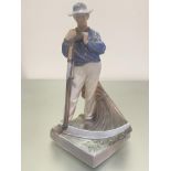 A Royal Copenhagen Danish porcelain figure of a farmer with his scythe, decorated with polychrome