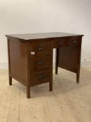 A mahogany knee hole desk, circa 1930s, fitted with six drawers, raised on stile supports, H76cm,