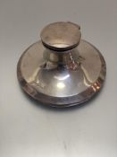 A Birmingham silver Capstan style circular inkwell with lift-up top, (h 5.5cm x d 10cm), missing