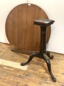 A Georgian mahogany tilt top table, the circular top raised on turned column and triple splay