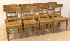 A set of eight Victorian style pine dining chairs, with acanthus carved rail backs, raised on turned
