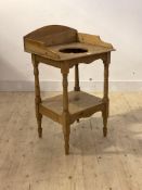 A Victorian pine wash stand, the top with raised back and edge and wash bowl recess raised on turned