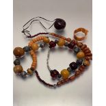 A collection of amber and amberoid necklaces, bracelets etc, in the Nepalese style, with white metal