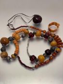 A collection of amber and amberoid necklaces, bracelets etc, in the Nepalese style, with white metal