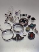 A collection of silver and white metal jewellery including an Edwardian engraved stiff hinged