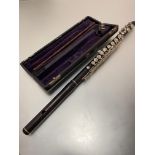 A 19thc rosewood and white metal mounted three part flute by Adler & Co, Markneukrchen Trade H.E,
