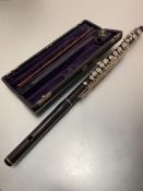 A 19thc rosewood and white metal mounted three part flute by Adler & Co, Markneukrchen Trade H.E,