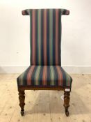 A Victorian rosewood prie dieu chair, upholstered in later fabric, raised on turned front supports