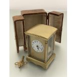 An Edwardian French four glass clock with arched top and enamel dial with arabic numerals,