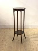An Edwardian mahogany jardiniere stand, the circular top raised on square splayed supports united by