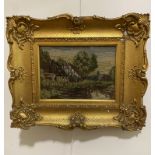 A wool work panel depicting cottages by stream, in gilt composition frame a/f, (19cm x 26cm)