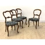 A harlequin set of four Victorian balloon back dining chairs, one pair in rosewood and the other