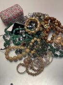 A jadeite oval bead necklace, a horn graduated bead necklace and treen graduated bead necklace,