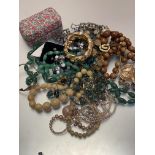 A jadeite oval bead necklace, a horn graduated bead necklace and treen graduated bead necklace,