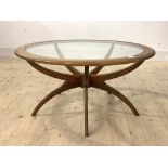 Victor B Wilkins for G-Plan, A mid century teak 'Spider' coffee table, with circular glass inset top