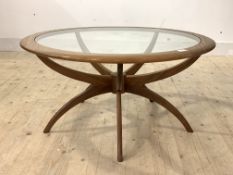 Victor B Wilkins for G-Plan, A mid century teak 'Spider' coffee table, with circular glass inset top