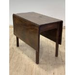 A George III mahogany drop leaf table, raised on square moulded and chamfered supports, H70cm L91cm,