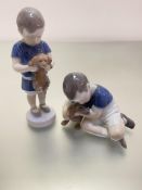 A Bing and Grondahl Danish figure of a boy holding a puppy and a Royal Copenhagen Danish porcelain