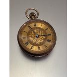 An Edwardian ladies Swiss 9ct gold fob watch with gilt engraved dial and roman numerals, engraved