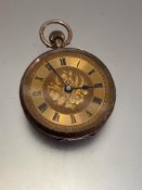 An Edwardian ladies Swiss 9ct gold fob watch with gilt engraved dial and roman numerals, engraved