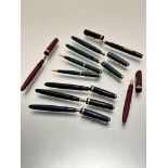A collection of Parker fountain pens and propelling pencils including two maroon coloured Parker