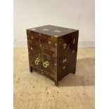 A Chinese bed side cupboard, red lacquered and with gilt chinoiserie decoration, fitted with a