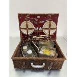 A Sirram Picnic set with red leather lining and fitted interior, with three forks, four knives, four