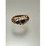 An Edwardian yellow metal five-stone ring, set a central three-stone sapphire and two-stone