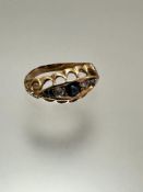 An Edwardian yellow metal five-stone ring, set a central three-stone sapphire and two-stone