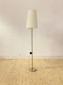 A contemporary lamp standard, the chrome stem united to the circular base with a ball joint,