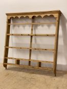 A 19th century pine four height Delft rack, the moulded cornice over shaped apron, two plate shelves