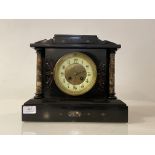 A late Victorian architectural slate mantel clock, with marble pilasters flanking an ivorine dial