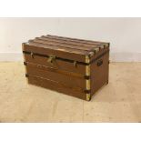 An early 20th century wood and metal bound steamer trunk, with carry handle to each end, H50cm,