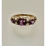 A 9ct gold Edwardian style three-stone amethyst and cluster ring, set four seed pearls, mounted in