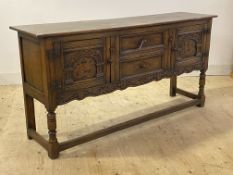 An 18th century style oak dresser base, fitted with two centre drawers flanked by two arcaded