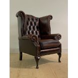 A Quality Georgian style wingback armchair, upholstered in deep buttoned and studded oxblood