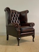 A Quality Georgian style wingback armchair, upholstered in deep buttoned and studded oxblood