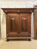 A 20th century Continental oak schrank cupboard, in the baroque style, the projecting cornice over