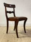 A Regency mahogany side chair, with scrolled rail back over leather upholstered seat pad, raised