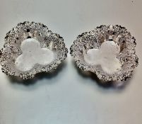 A pair of Sheffield cloverleaf shaped chased bon bon dishes with c scroll and foliate style borders,