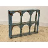 An Indian style hardwood two tier arcaded wall shelf, finished in distressed blue paint, H64cm,