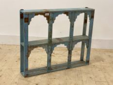 An Indian style hardwood two tier arcaded wall shelf, finished in distressed blue paint, H64cm,