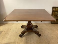 A mid 19th century mahogany snap top dining table, the top raised on a baluster column and