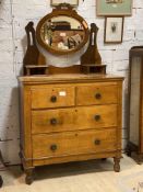 An Edwardian satin walnut dressing chest, the oval swing mirror over two trinket drawers, the base