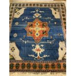 A Large Turkish hand knotted carpet, the blue field with star medallion enclosed by a guarded border